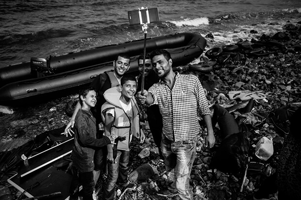 A group of young men posed for a selfie on Eftalou beach after reaching the island.