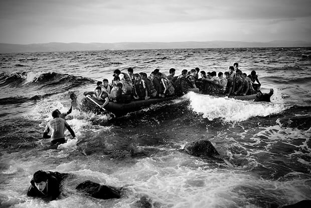 A boat with 45 refugees from Afghanistan reached the north coast of Lesbos. The swell is high and the journey dangerous. Spanish life guards, helping people off the boat.